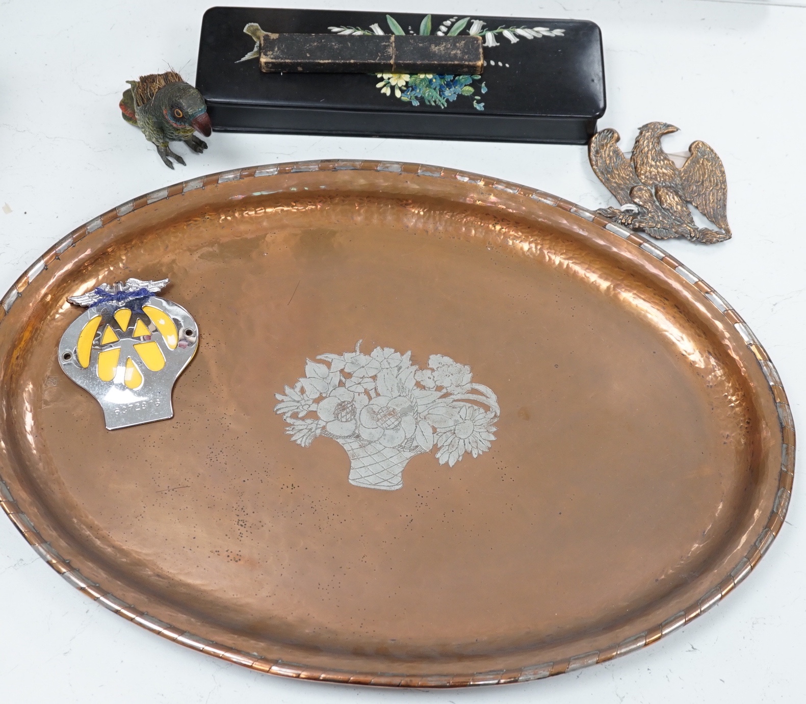 A large oval copper tray, cold-painted spelter parrot and four other items